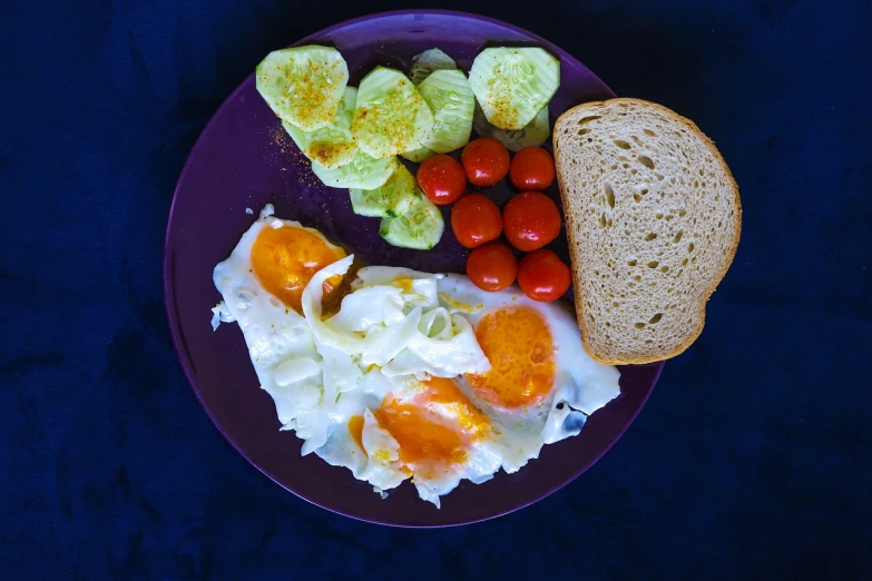 a purple plate topped with eggs, tomatoes and bread, a picture, inspired by Slava Raškaj, pixabay, bauhaus, thailand, morning lighting, with a white, foil