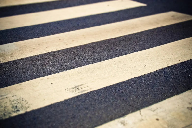 a close up of a crosswalk on a city street, a picture, by Thomas Häfner, shutterstock, finely textured, striped, telephoto shot, stock photo