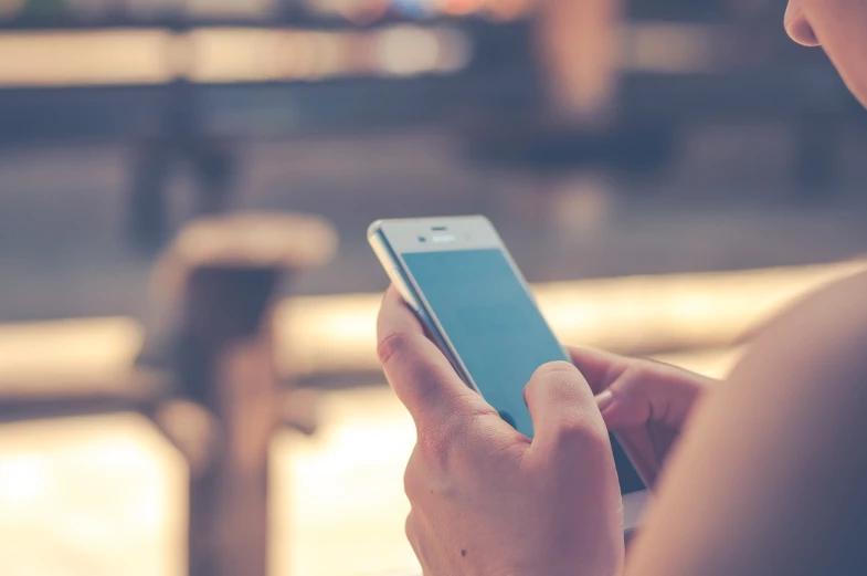 a close up of a person holding a cell phone, happening, shaded, istock, responsive, phation