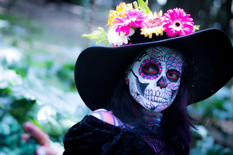 a close up of a person wearing a hat with flowers on it, pexels, ( ( ( el dia los muertos ) ) ), beautiful girls, body painted with black fluid, 5 feet away