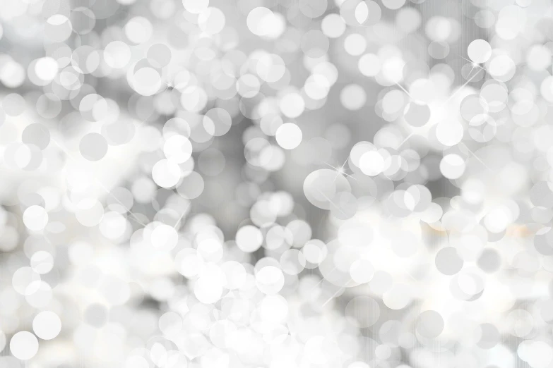 a black and white photo of a blurry background, inspired by Évariste Vital Luminais, white sparkles everywhere, background image, glittering silver ornaments, white pearlescent