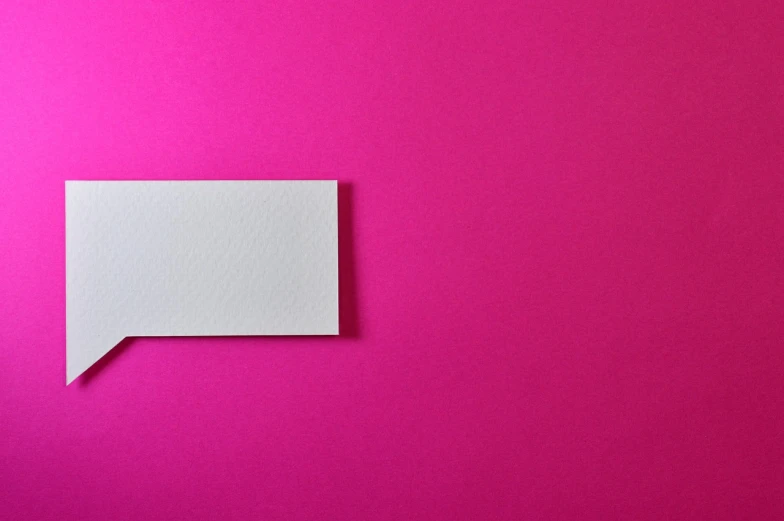 a piece of paper sitting on top of a pink surface, a photo, postminimalism, business card, modern very sharp photo, wide screenshot, white color