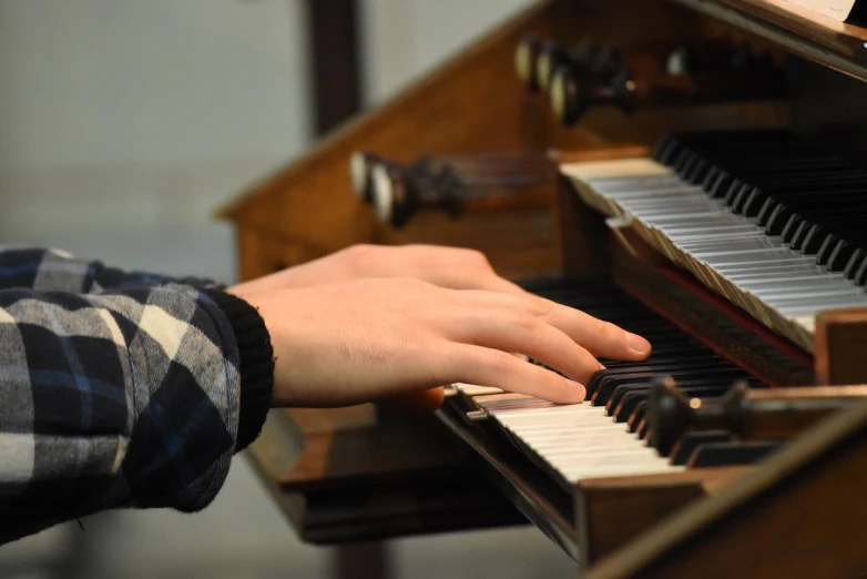 a close up of a person playing an organ, in church, student, hand photography, [ [ hyperrealistic ] ]