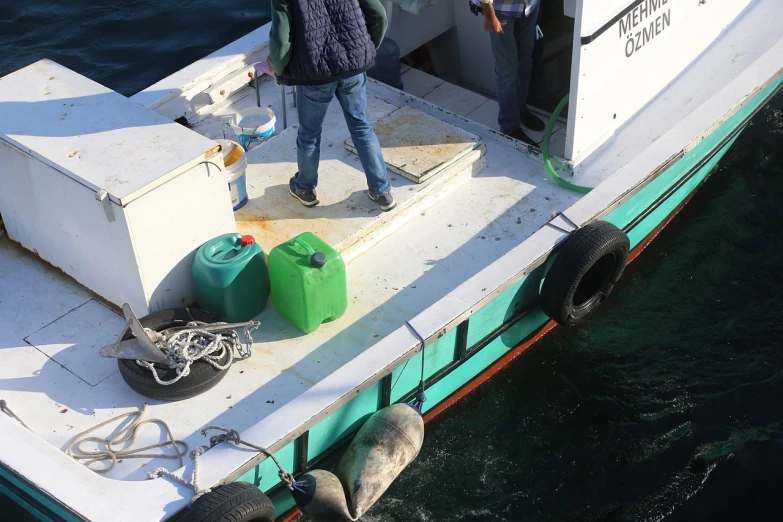 a man standing on top of a boat in the water, a photo, a group photo of a seal, usa-sep 20, fishing boat, full of greenish liquid