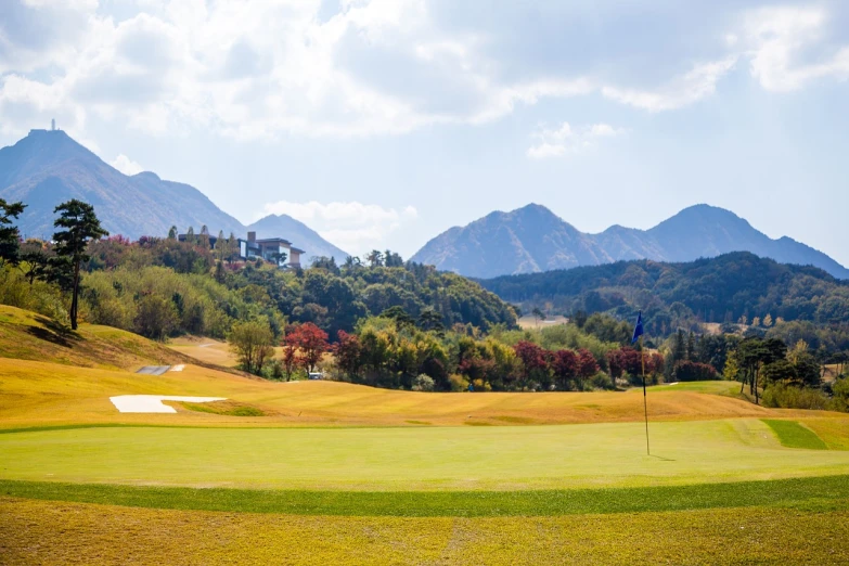 a golf course with mountains in the background, shutterstock, shin hanga, grassy autumn park outdoor, ground level view, bottom angle, hong soonsang