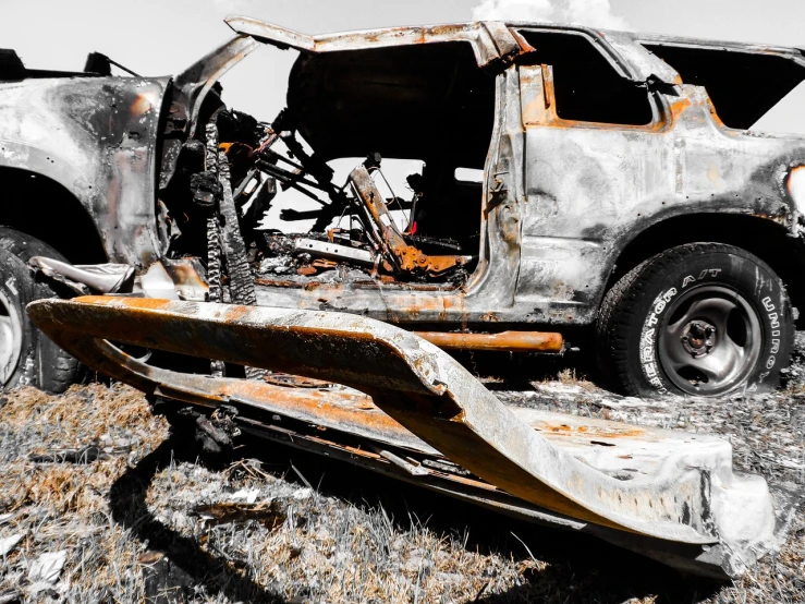 a burnt out truck sitting on top of a grass covered field, a portrait, unsplash, auto-destructive art, high contrast, car crash test, usa-sep 20, intense detail