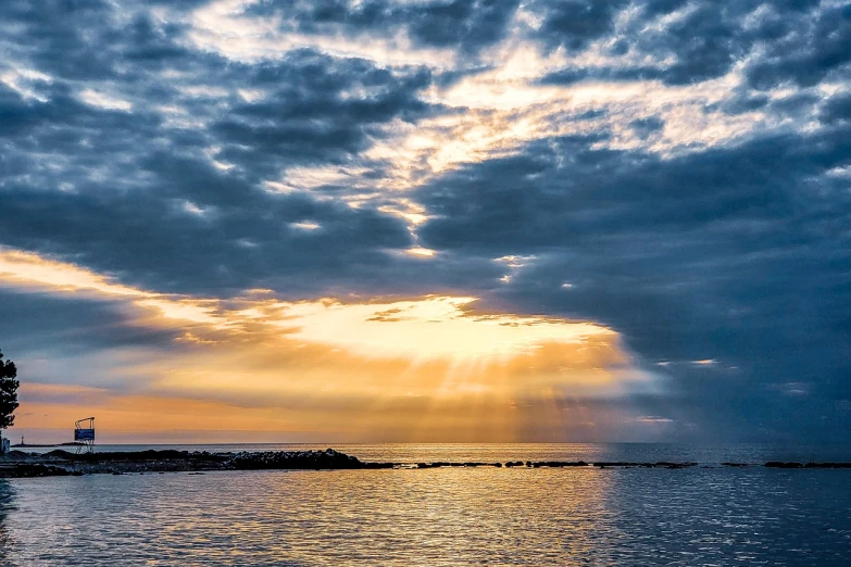 a large body of water under a cloudy sky, a picture, by Julian Allen, pexels, sunrays shine upon it, good morning, today\'s featured photograph 4k, shot on nikon z9