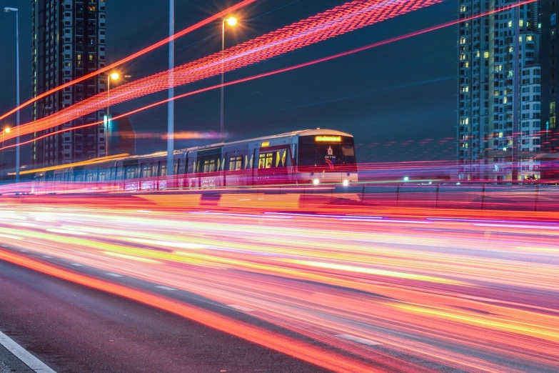 a street filled with lots of traffic next to tall buildings, by Oskar Lüthy, pexels contest winner, high speed trains, traffic with light trails, ( ( ( buses, inside of a metro train