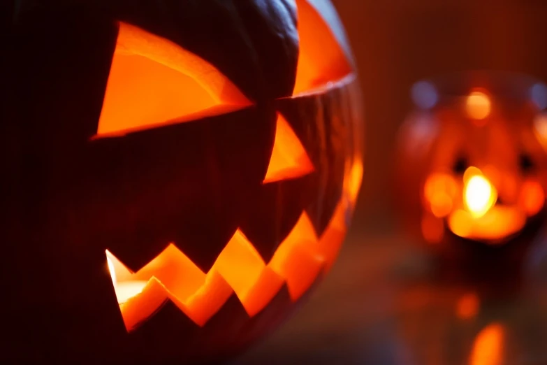 a couple of carved pumpkins sitting on top of a table, shutterstock, spooky found footage, closeup - view, creeptastic, year 2 8 6 6