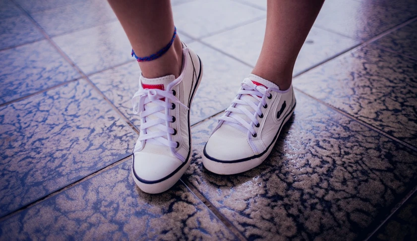 a close up of a person's shoes on a tiled floor, a stock photo, antipodeans, little kid, cool white, teenage girl, sneaker photo