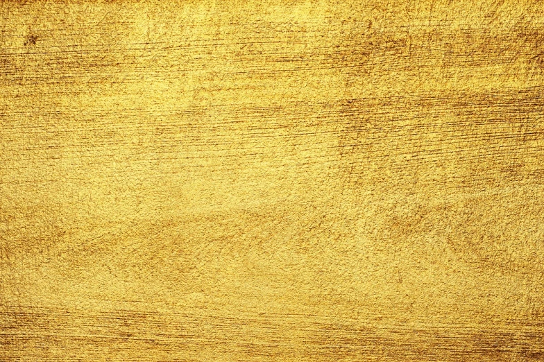 a close up of gold paint on a wooden surface, a stock photo, by Bernard Meninsky, shutterstock, art deco, very grainy texture, bird's view, savana background, golden halo