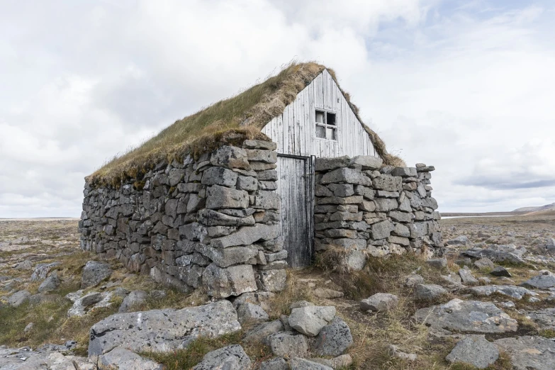 a stone building with grass on top of it, by Hallsteinn Sigurðsson, pixabay, inuit, shed, by joseph binder, half - length photo