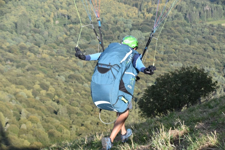 a man flying through the air while holding onto a parachute, a picture, by Erwin Bowien, shutterstock, figuration libre, carrying a saddle bag, view from the back, over the hills, alexi zaitsev