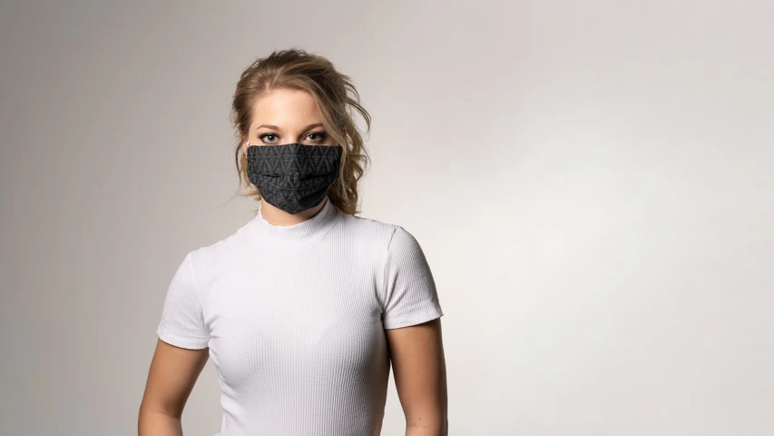 a woman in a white shirt and a black mask, all black matte product, made of lab tissue, carved black marble, productphoto