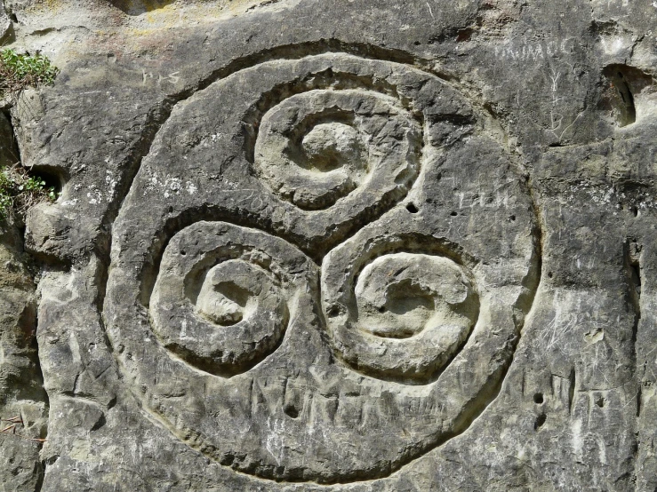 a close up of a rock with carvings on it, inspired by Károly Markó the Elder, flickr, land art, high detail spiral design, trio, st cirq lapopie, ankh symbol