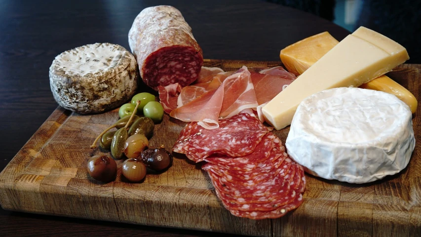 a wooden cutting board topped with meat and cheese, by Tom Wänerstrand, photo taken in 2 0 2 0, various posed, glasgow, very very well detailed image