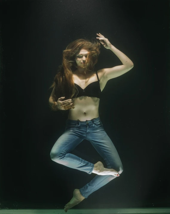 a woman that is in the water with a surfboard, a portrait, by Elizabeth Polunin, figuration libre, ( ( ( wearing jeans ) ) ), suspended underwater, shot at dark with studio lights, in style of nan goldin