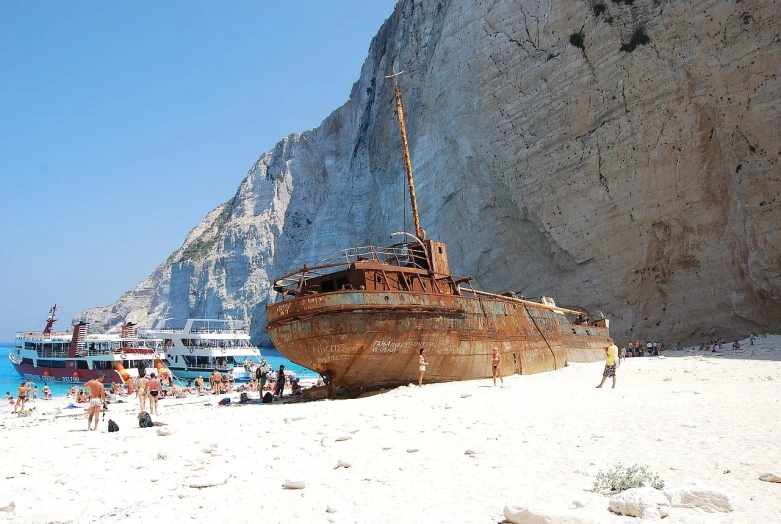 a boat sitting on top of a sandy beach, a photo, shipwrecks, greek nose, style of chippy, yellowed with age