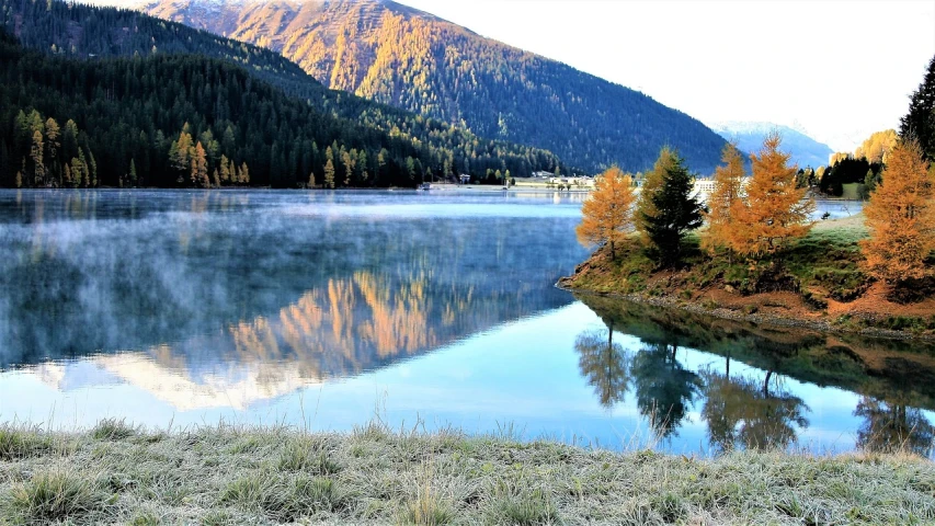 a body of water surrounded by trees and mountains, a picture, by Werner Andermatt, pixabay, romanticism, beautiful morning, during autumn, italy, beautiful pine tree landscape