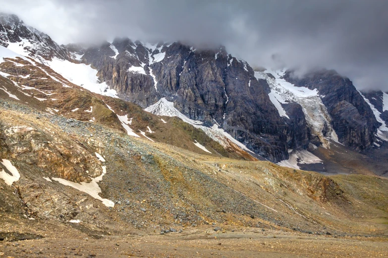 a horse that is standing in the dirt, a detailed matte painting, shutterstock, glaciers and ice and snow, low clouds after rain, high angle vertical, hiking in rocky mountain