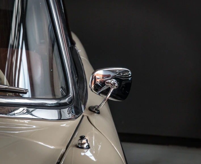 a close up of a car's side view mirror, a portrait, by Etienne Delessert, high detail photo, classic chrome, horns with indicator lights, front and side views