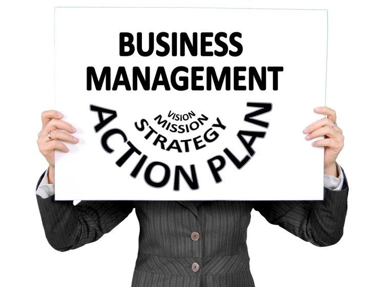 a person holding a sign that says business management action plan, by Daphne Allen, steady look, multi-part, modern very sharp photo, full image