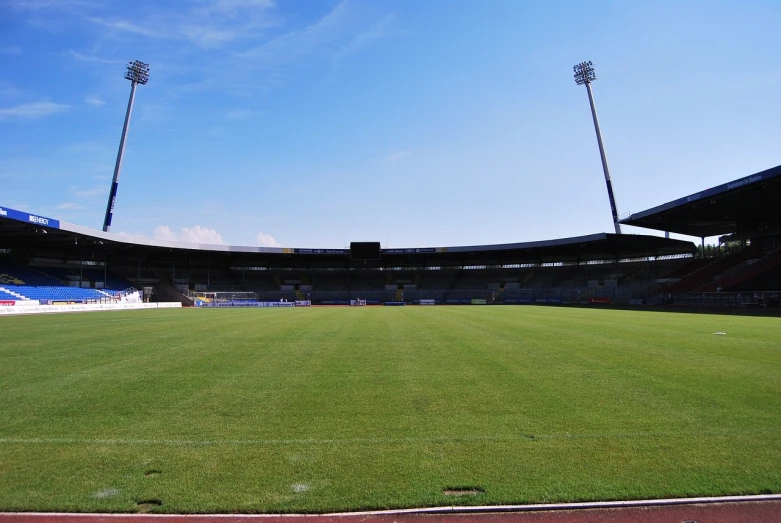 a stadium filled with lots of green grass, a picture, by Werner Gutzeit, shutterstock, in empty!!!! legnica, caulfield, wikimedia, ground - level view