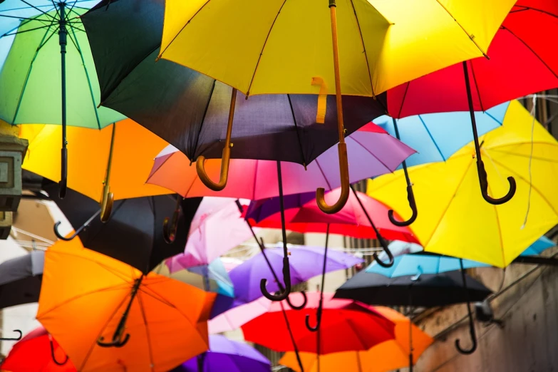 a bunch of colorful umbrellas hanging from the ceiling, a picture, by Jakob Gauermann, shutterstock, raining outside, stock photo, close - up photo, sao paulo