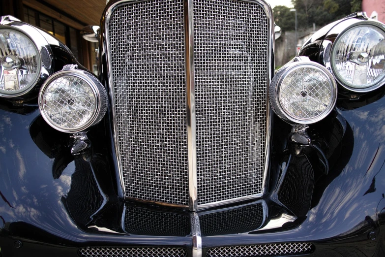 a close up of a car's grill and headlights, a stipple, by Jim Nelson, flickr, flapper, mesh wire, avalon, great detail. 2 4 mm