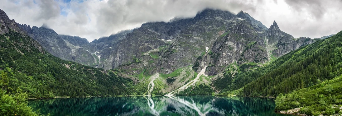 a large body of water surrounded by mountains, by Aleksander Gierymski, pexels contest winner, poland, ornately detailed, bad photo, stock photo