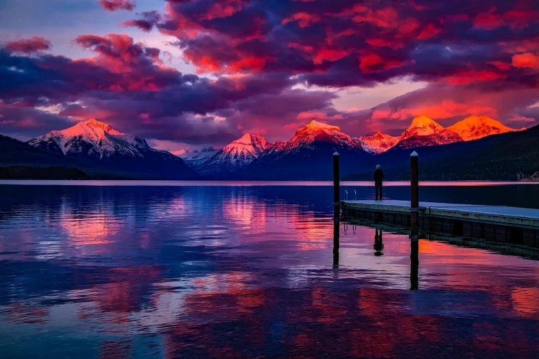 a dock next to a body of water with mountains in the background, a picture, by Jim Nelson, shutterstock, fine art, blood red colored sky, magenta and blue, hd phone wallpaper, 4k hd wallpaper