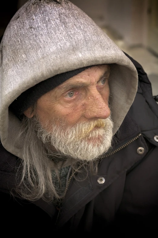 a close up of a person wearing a hoodie, by Jan Konůpek, pexels, photorealism, donald trump as a homeless man, older male, russian shaman, he also wears a grey beanie