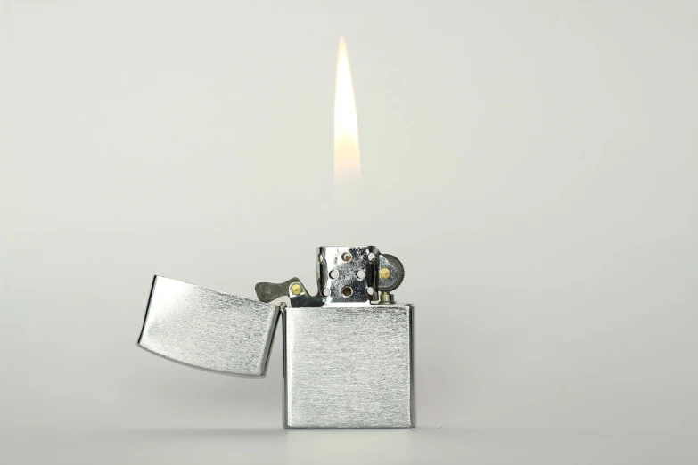 a lighter that is sitting on top of a table, a stock photo, minimalism, flame conjuring armored, highly detailed product photo