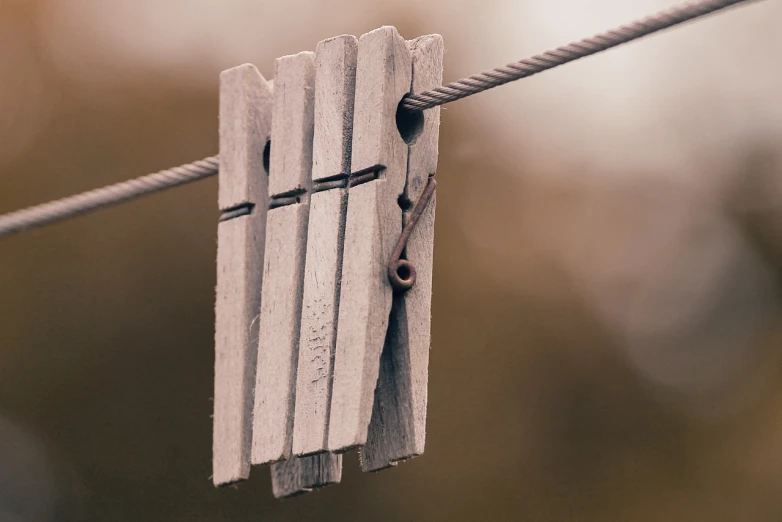 a close up of clothes pegs on a clothes line, unsplash, renaissance, rough wooden fence, grayish, really realistic, tiny details