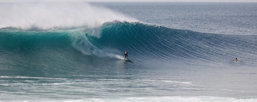 a man riding a wave on top of a surfboard, by Clint Cearley, pexels contest winner, sumatraism, big man, lone female, pipe, 2014