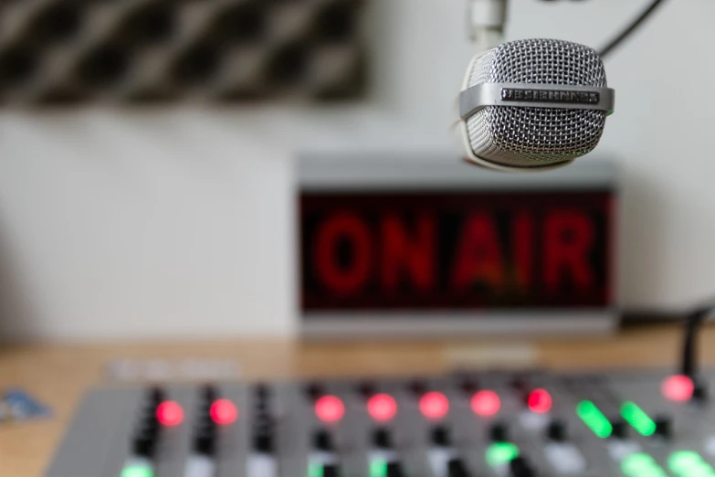 a microphone sitting on top of a wooden table, a picture, shutterstock, radio equipment, panel, stock photo, in a studio