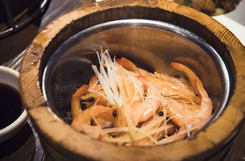 a close up of a bowl of food on a table, mingei, ghostshrimp, wooden bowl, featured