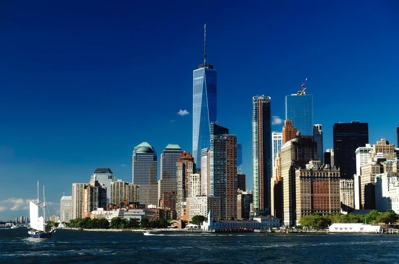 a large body of water with a city in the background, a photo, by Robert M. Cunningham, shutterstock, new york backdrop, photo taken from a boat, ultra wide 1 0 mm, modern high sharpness photo