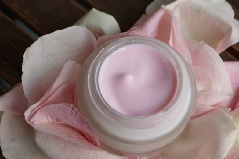 a close up of a jar of cream on a flower, a digital rendering, by Rhea Carmi, pexels, smooth pink skin, rose quartz, manicured, high quality product photo