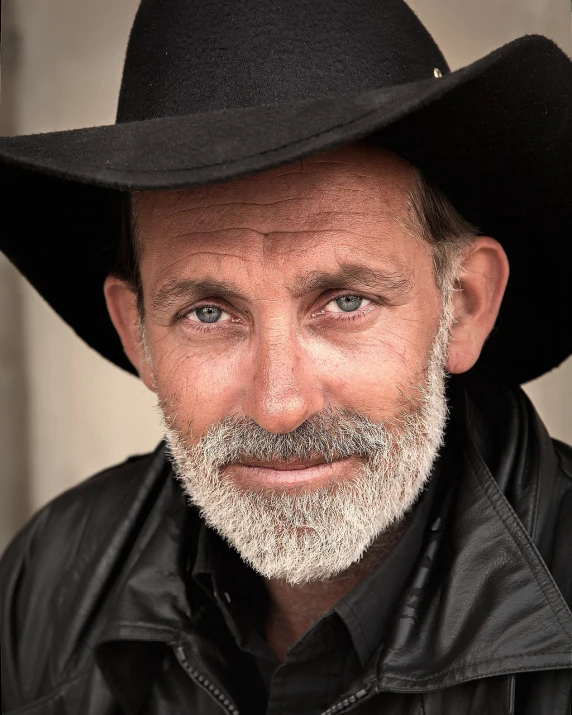 a close up of a person wearing a hat, a photo, by Thomas Bock, trending on pixabay, photorealism, bearded cowboy, portrait of hugh laurie, black cowboy, paris 2010