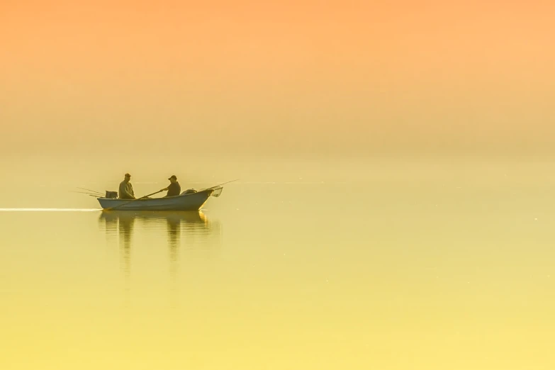 a couple of people that are in a boat in the water, a photo, by Richard Carline, sunrise colors, minimalist environment, fishing, yellow