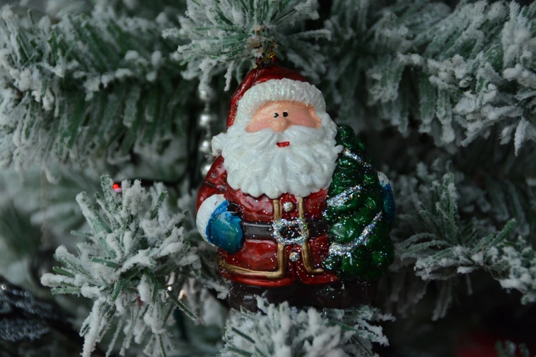 a close up of a christmas ornament on a tree, a photo, folk art, santa claus, toy photo