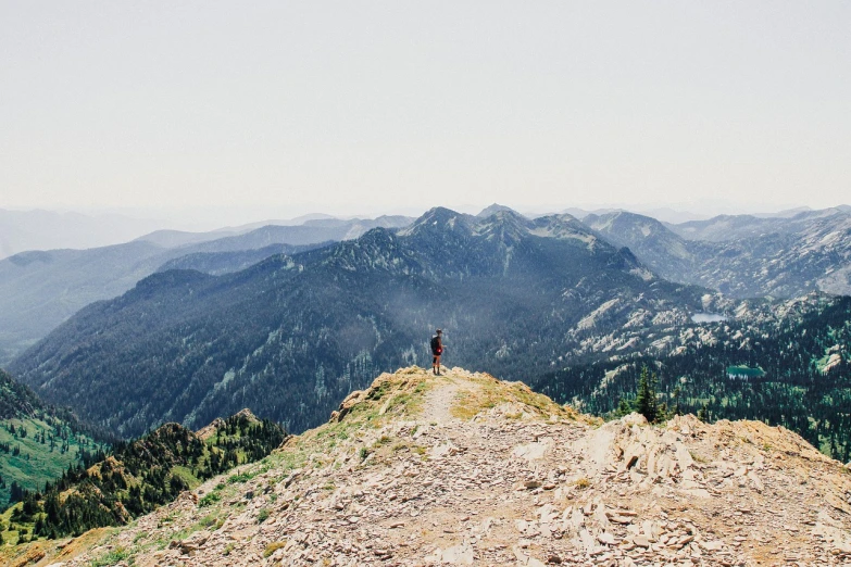 a person standing on top of a mountain, by Morgan Russell, pacific northwest, flickr explore 5 0 mm, “wide shot, long shot from back