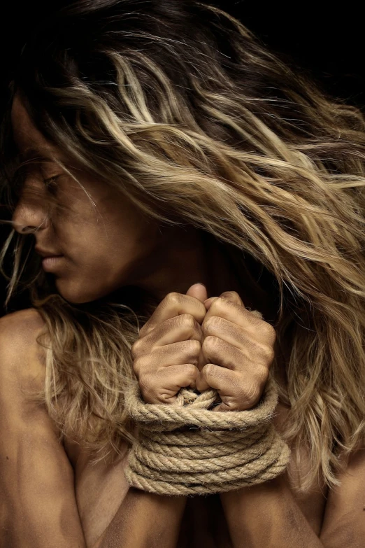 a close up of a person holding a rope, a portrait, by Steven Belledin, figuration libre, wavy hair spread out, zoe saldana, muscular and exhausted woman, with long blond hair