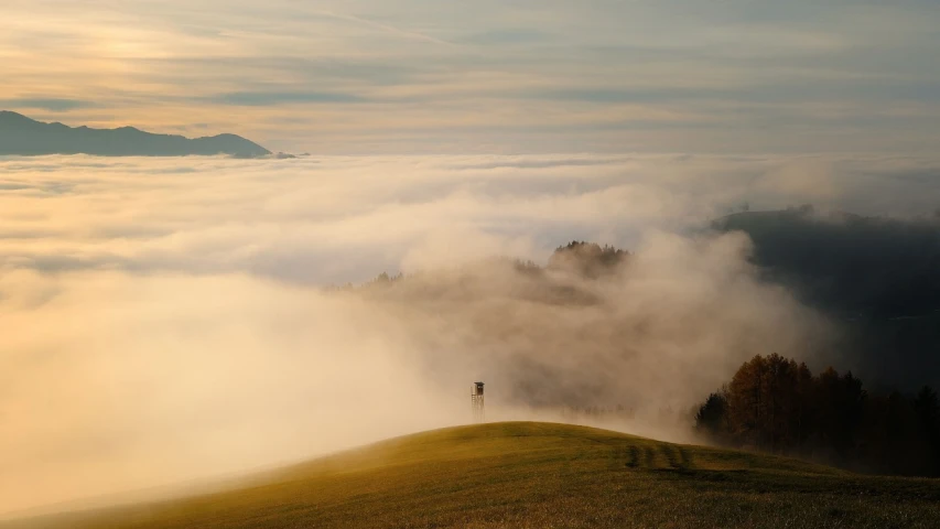 a person standing on top of a grass covered hill, by Sebastian Spreng, pexels contest winner, romanticism, above low layered clouds, abbondio stazio, (by tom purvis), wikimedia commons