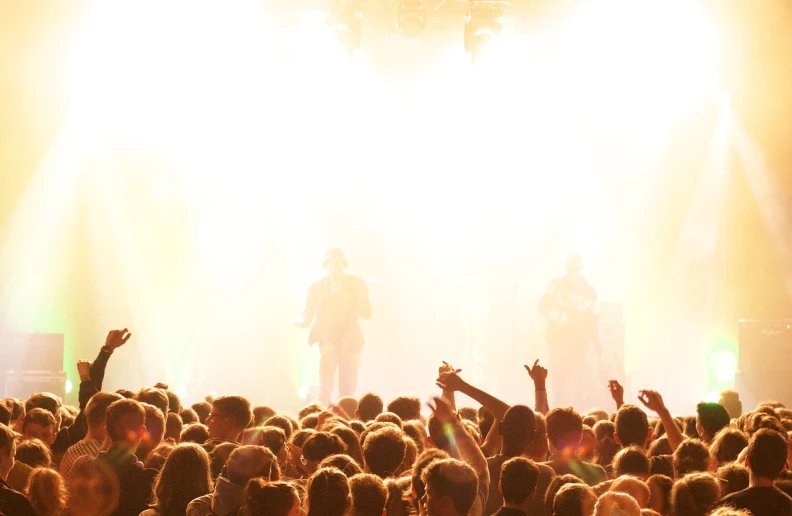 a group of people that are standing in front of a stage, pexels, huge crowd on drugs, backlight glow, istock, 2012