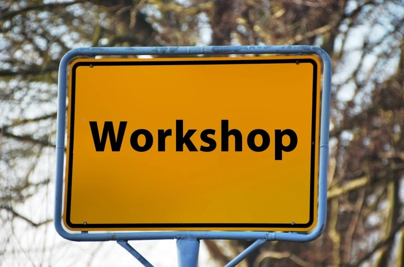 a yellow sign with the word workshop on it, a picture, realism, modern very sharp photo, stock photo