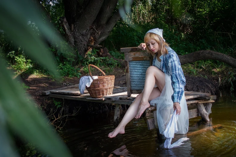 a woman sitting on top of a wooden dock next to a river, a portrait, inspired by Anders Zorn, renaissance, cosplay of a catboy! maid! dress, with an easter basket, wet feet in water, wearing a white bathing cap