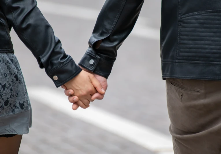 a close up of two people holding hands, by Maksimilijan Vanka, shutterstock, wearing samcrow leather jacket, walking to the right, lgbtq, blog-photo