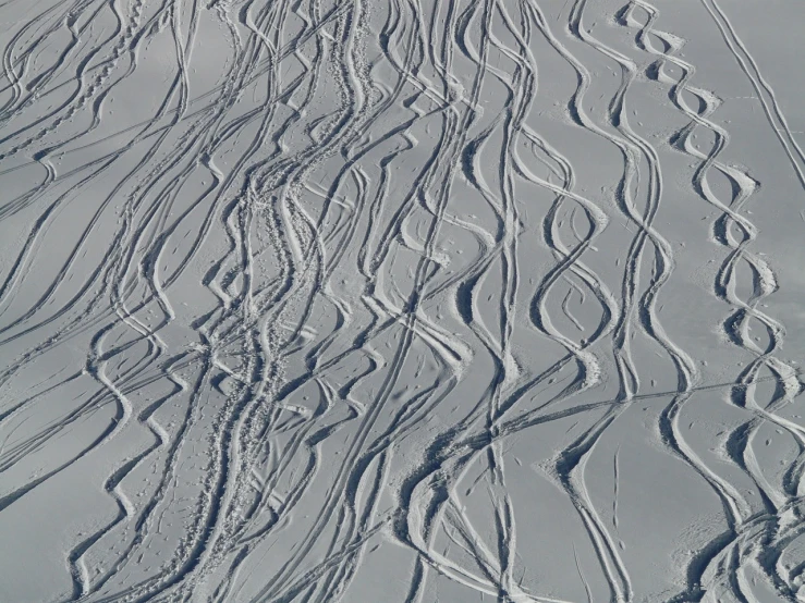 a man riding skis down a snow covered slope, a stipple, inspired by Jules Olitski, flickr, op art, texture detail, swirly lunar ripples, chairlifts, 3 meters